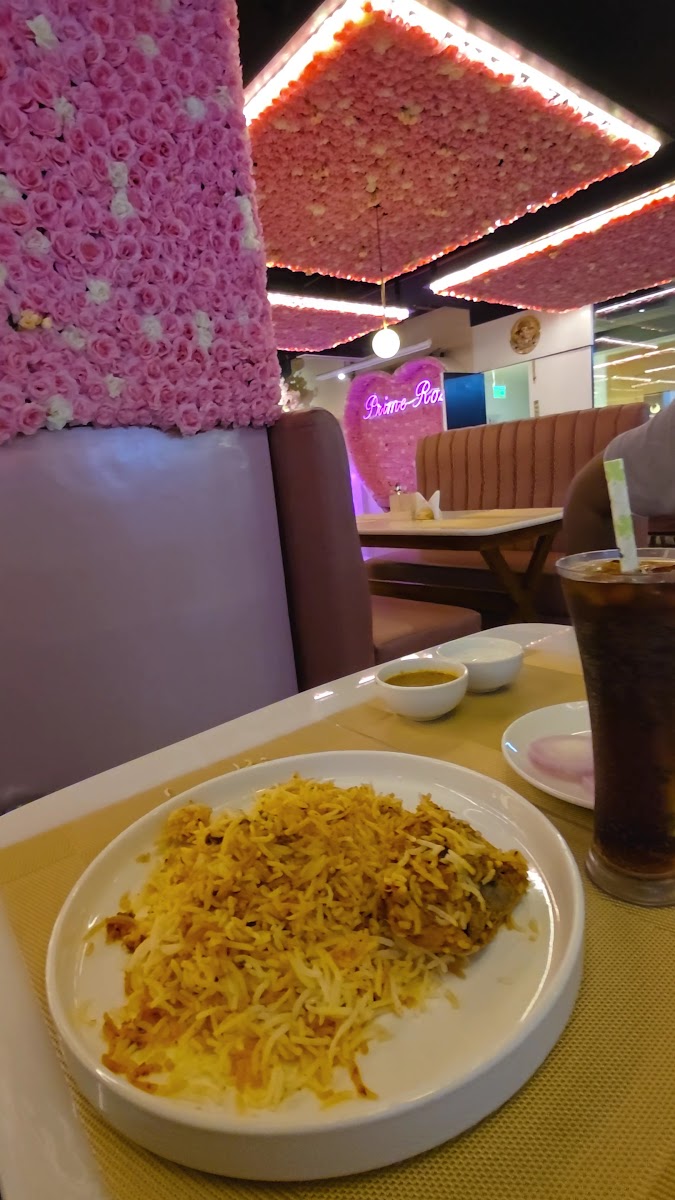 Prime Rose Restaurant pink floral interior with a biryani spread